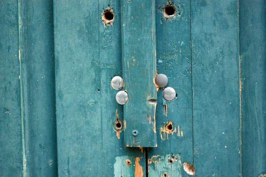 Vintage wooden blue door macro. Weathered wood background texture.