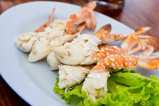 Piles of crab legs on a plate.