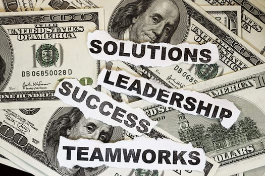 Solutions, leadership,teamworks and success words on dollar- many uses on bussiness.