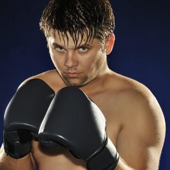 The boxer. The young man in boxing gloves