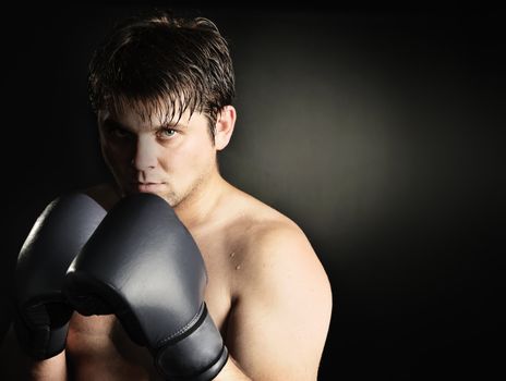 The boxer. The young man in boxing gloves