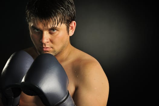 The boxer. The young man in boxing gloves
