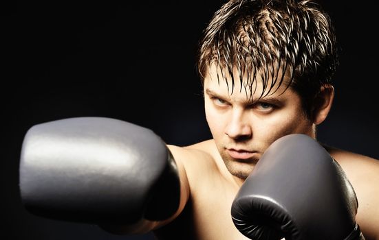 The boxer. The young man in boxing gloves