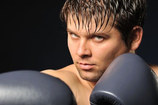 The boxer. The young man in boxing gloves