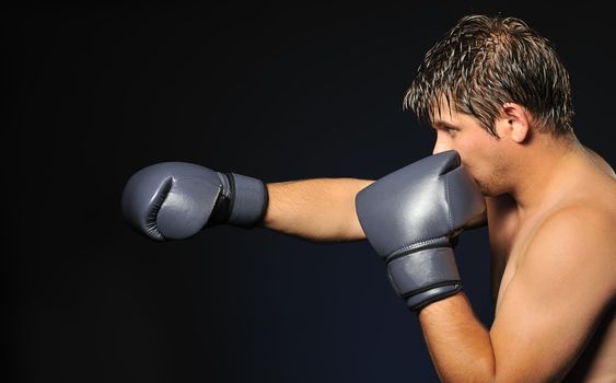The boxer. The young man in boxing gloves