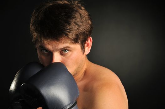 The boxer. The young man in boxing gloves