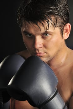 The boxer. The young man in boxing gloves