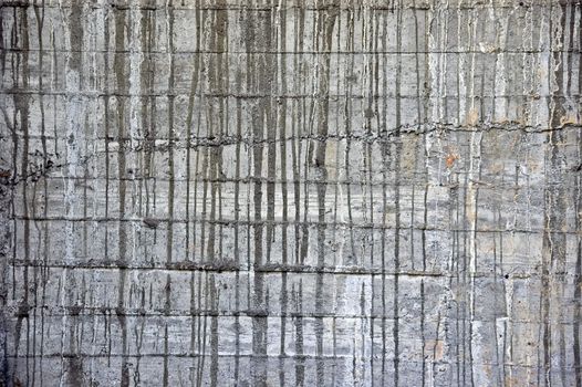 Concrete wall with dripping paint stains. Abstract texture.