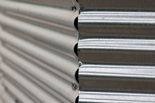 Corrugated metal fence abstract background. Selective focus.