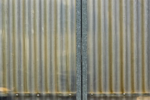 Weathered corrugated plastic sheet and metal background texture.