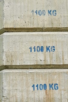 Concrete counterweight blocks used in building construction.