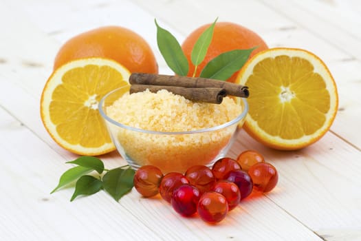 bowl of orange bath salt with fresh fruits - beauty treatment