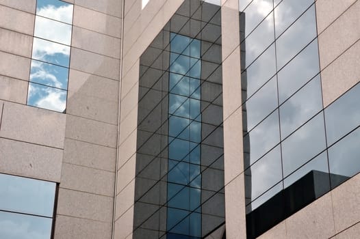 Sky reflected on glass building exterior. Modern architecture.