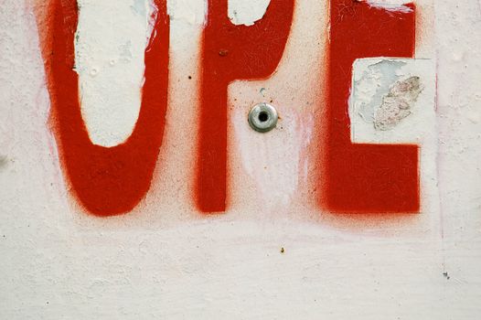 Weathered letters stencil on rough surface. Abstract background texture.