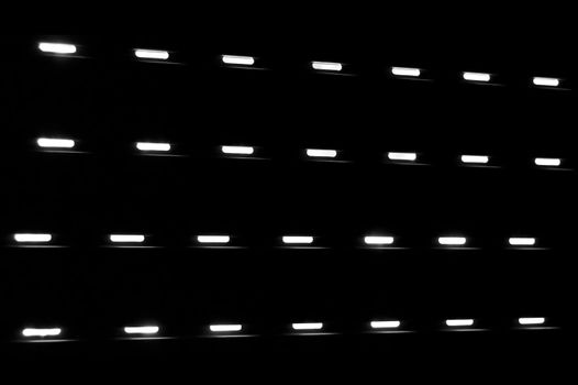 Dim light shining through a closed window shutter. Black and white.