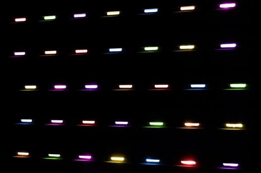 Colored lights shining through a window shutter. Abstract background.