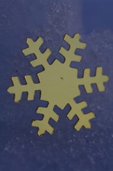 golden snow stars on a real snowy icy surface