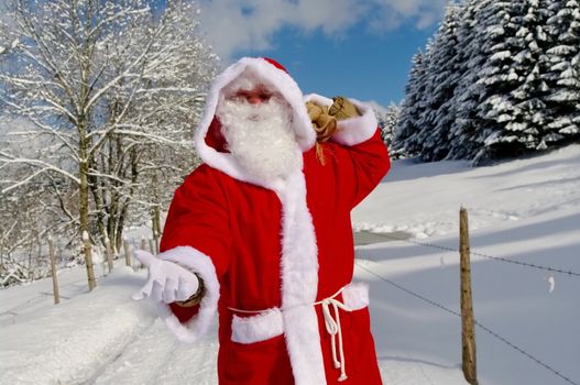 Santa Claus, Father Christmas in a beautiful winter landscape