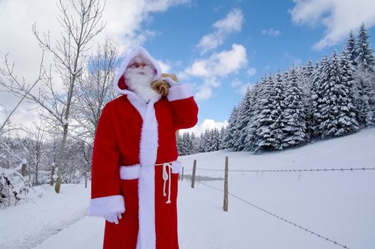 Santa Claus, Father Christmas in a beautiful winter landscape
