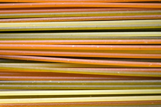 Multicolored spaghetti pasta texture. Abstract food background.