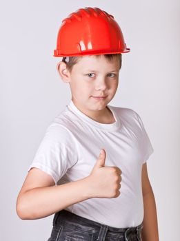 Portrait of a boy in a red protective helmet