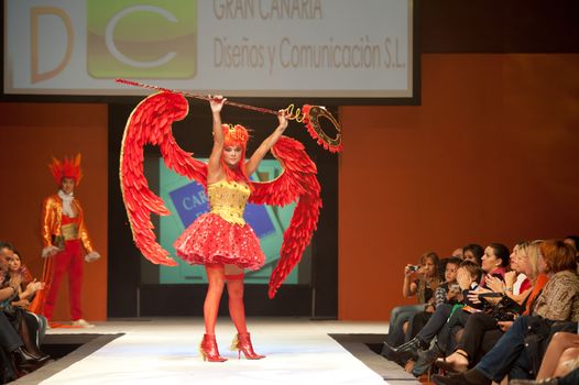 CANARY ISLANDS - 29 OCTOBER: Model on the catwalk wearing carnival costume from designer GC DC during Carnival Fashion Week October 29, 2011 in Canary Islands, Spain