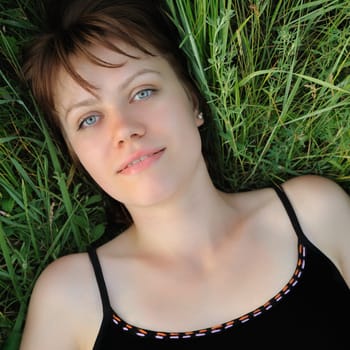 The girl in a grass. The young girl on green field