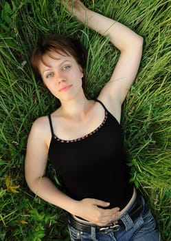 The girl in a grass. The young girl on green field