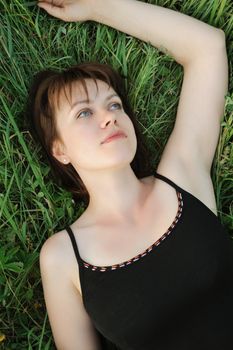 The girl in a grass. The young girl on green field