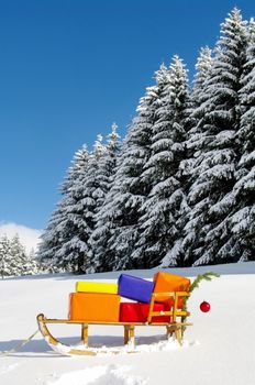 colorful presents on a Santa Claus sledge in a winter landscape