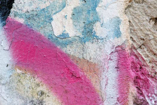 Paint stains on rough weathered wall surface.