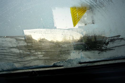 car windshield covered with ice and snow