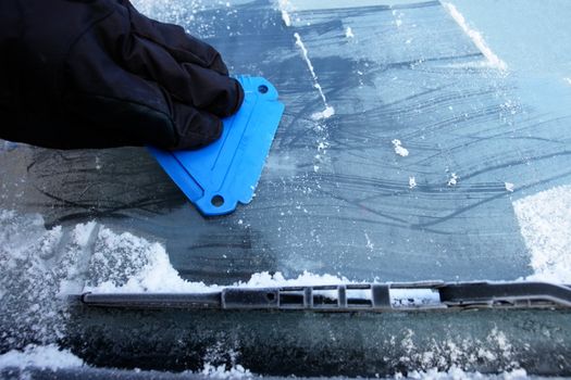 car windshield covered with ice and snow