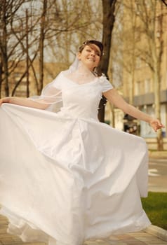 The bride. The young girl in a wedding dress on an abstract background