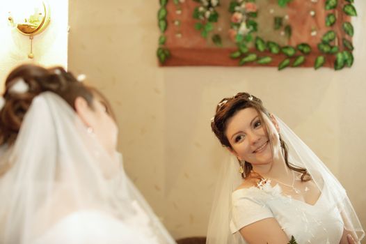The bride. The young girl in a wedding dress on an abstract background