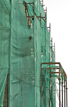 Abandoned 19th century mansion renovation. Torn scaffold debris netting.