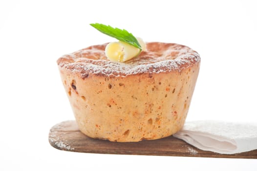 Homemade mediterranean bread with butter and a leaf of basil on a white background