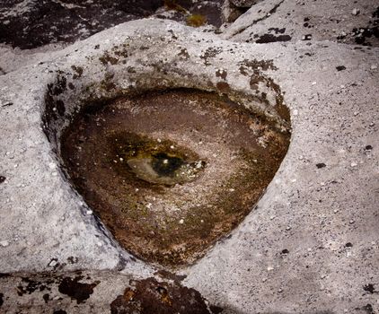 Perfect eye shape with iris and pupil in an eroded rock pool on a mountain top