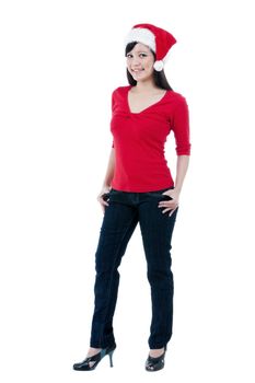 Full length portrait of a smiling Christmas woman wearing a santa hat over white background