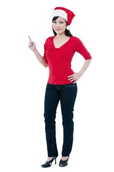 Full length portrait of a cute Christmas girl pointing against white background