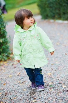 Clouse-up portrait pretty little girl walking in the park