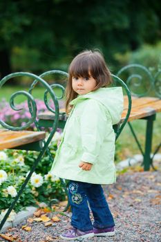 Clouse-up portrait pretty little girl walking in the park