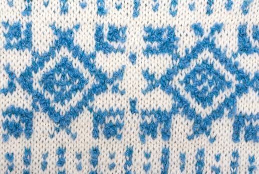 Knitted background with pattern in the manner of snowflakes, sweater