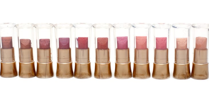 Lipstick in plastic case stands in row on white background