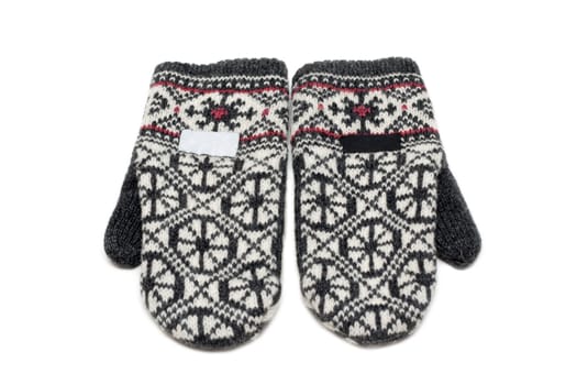 Knitted mittens on white background with pattern of the snowflake