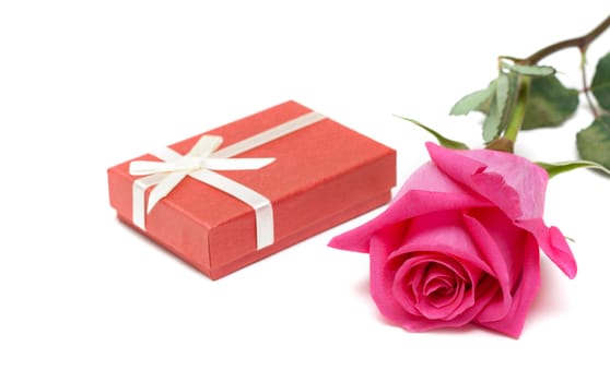 Red gift box and flower rose on white background
