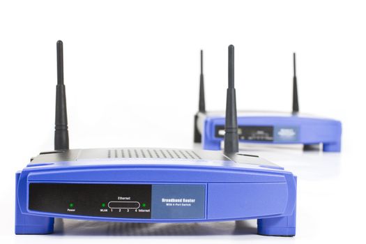 blue internet routers with two antennas. Isolated on white. One in background