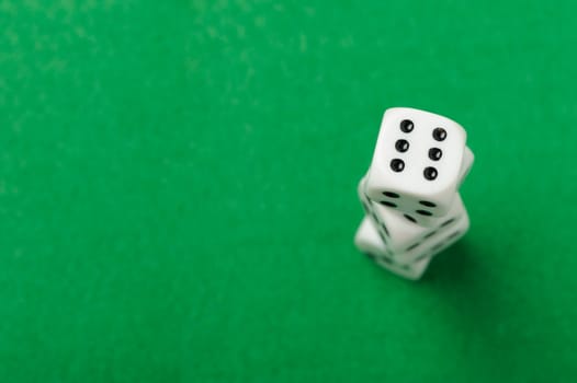 dices. Game cubes on a green background