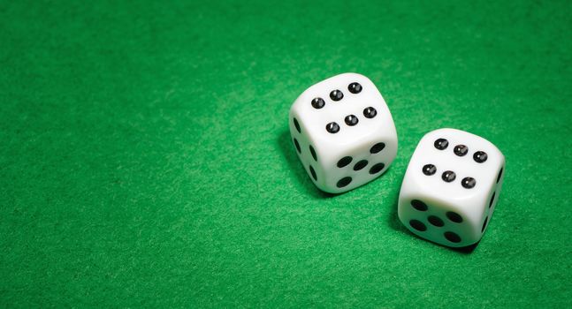 dices. Game cubes on a green background
