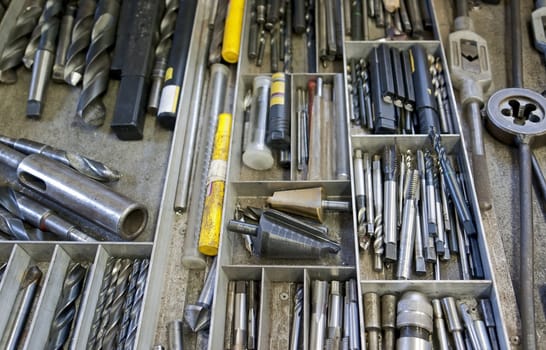 work tools in drawer: drill, screwplate, thread cutter, reamer